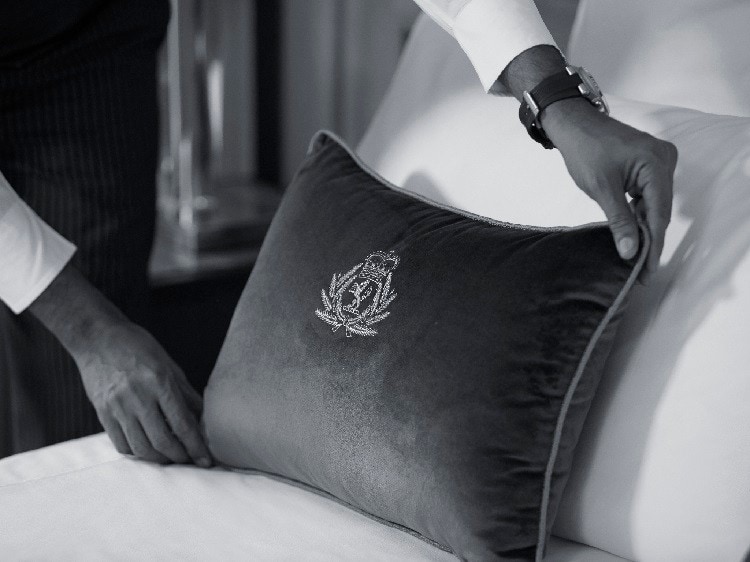 Butler places a pillow in a suite