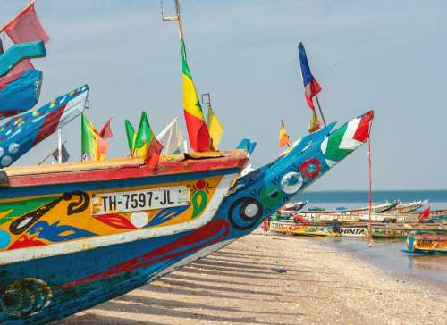Djiffer, Senegal - November 17, 2019: Traditional painted wooden fishing boat in Djiffer, Senegal. West Africa.