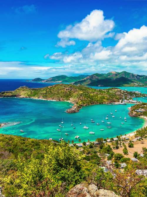 Beautiful bright and colorful aerial view of English harbor, Shirley Heights in Antigua, Caribbean. Landscape with blue sky and white clouds.