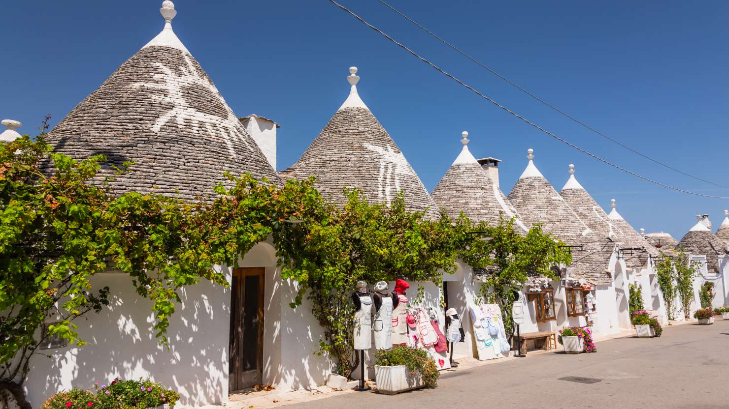 Alberobello is a small town located in the region of Puglia, in southern Italy. The town is known for its unique trulli houses, which are traditional dry-stone huts with conical roofs that are typical of the area. These houses are made using a technique that dates back to prehistoric times and are a UNESCO World Heritage Site.