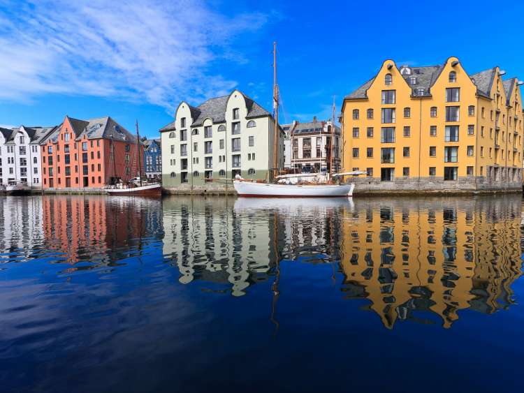 Sailing boats line the waterfront in Alesund, Norway