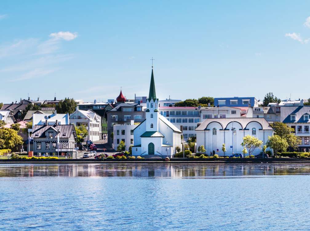 Attractive buildings line the waterfront of the lake in central Reykjavik