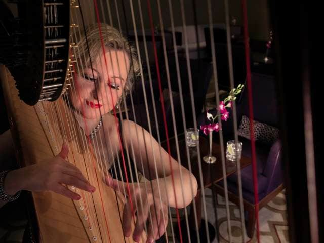 A harp player entertains guests in the Grills Lounge on board Cunard's flagship, Queen Mary 2