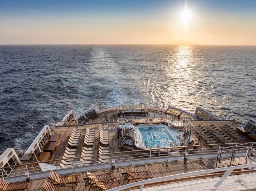 View from Aft on Queen Mary 2, showing Terrace pool and early sunset over the Atlantic Ocean