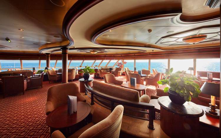 The Commodore Club on board Cunard's Queen Elizabeth, a stunning bar venue with ample seating and panoramic ocean views