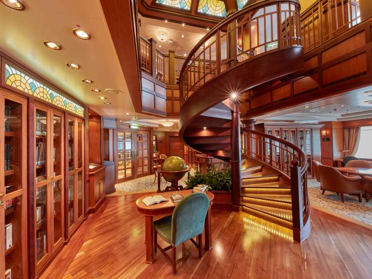 Library on board Cunard's Queen Elizabeth, with two levels of comfortable seating and floor-to-ceiling shelves