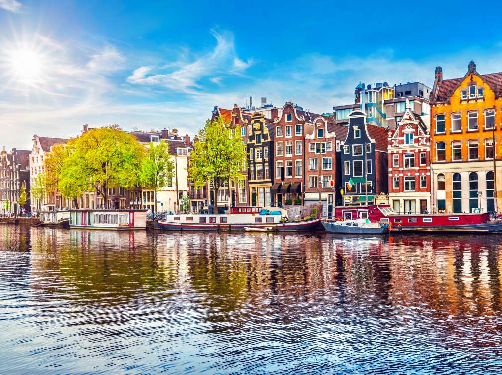 Amsterdam Netherlands dancing houses over river Amstel landmark in old european city spring landscape.; Shutterstock ID 656151523; purchase_order: 20240710; job: ; client: ; other: 