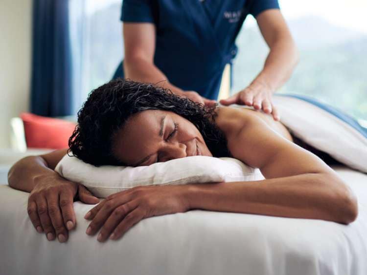 Woman enjoys massage in spa on board Cunard cruise ship