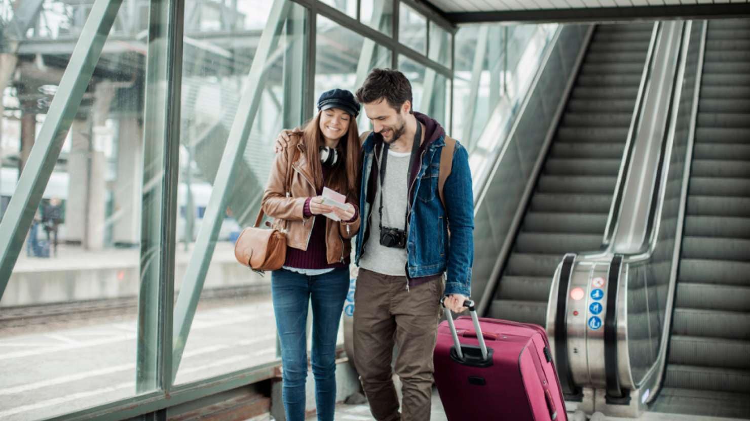 Young couple with luggage at terminal