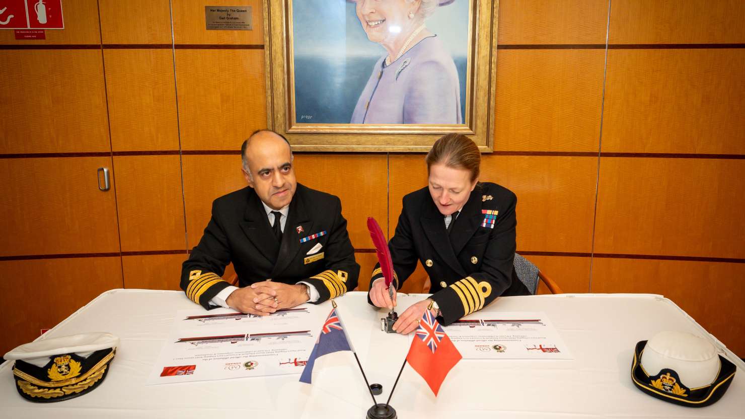 Captain Aseem Hashimi and Captain Claire Thompson signing the memorandum of affiliation