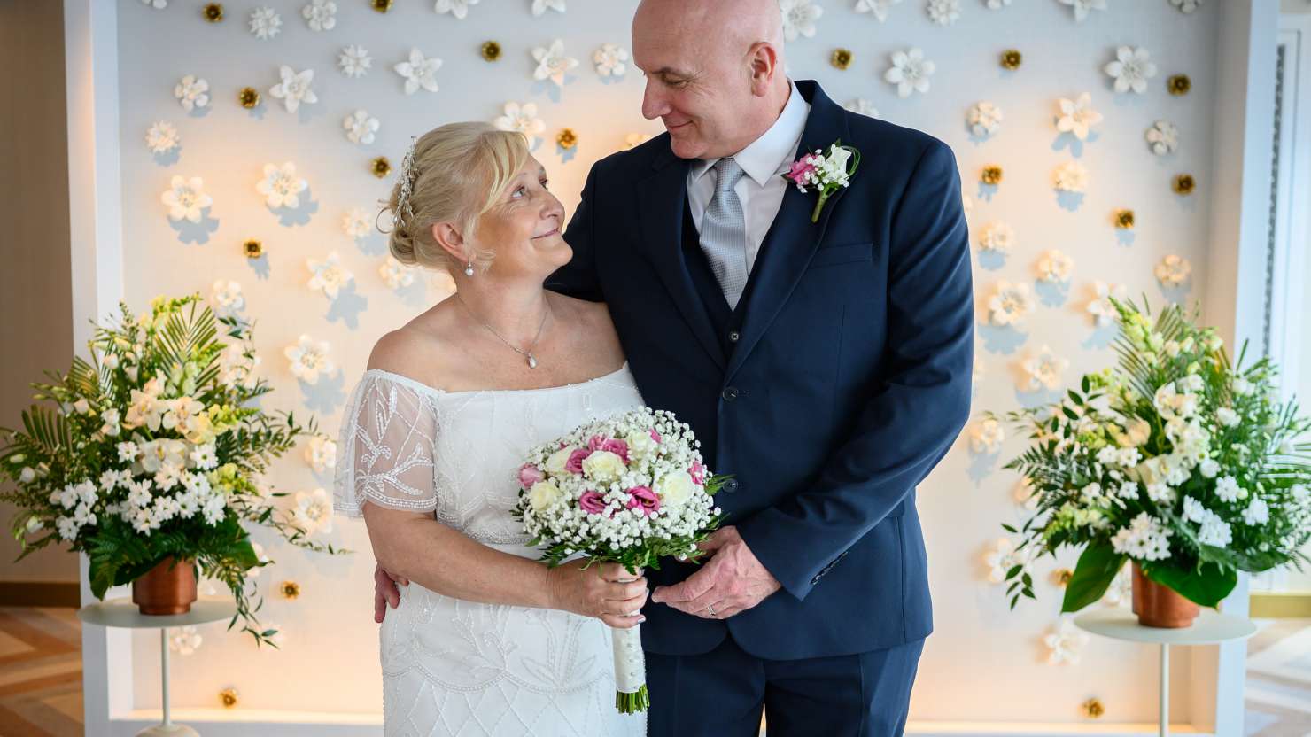 The smiling newlyweds pose for a photograph in the Admiral's Lounge after their ceremony 