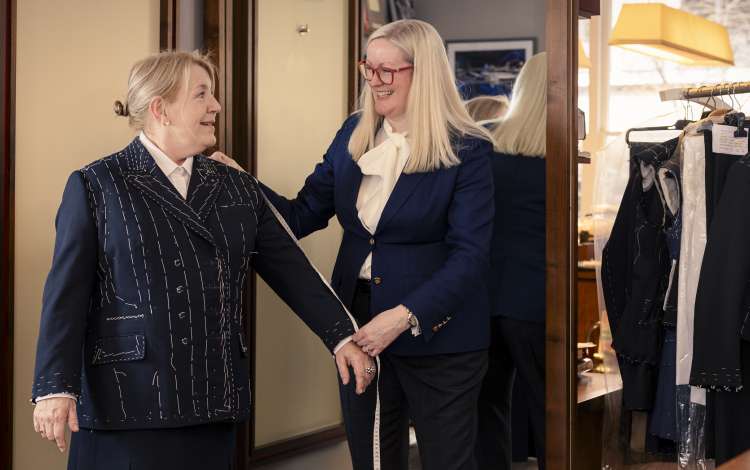 Master tailor Kathryn Sargent measures Captain Inger Thorhauge for her final uniform fitting 