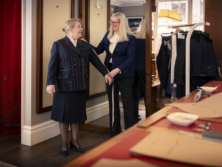 Master tailor Kathryn Sargent measures Captain Inger Thorhauge for her final uniform fitting 