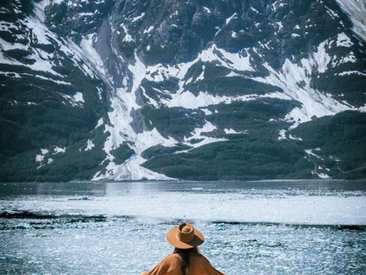 A woman views the Hubbard glacier from the deck of Queen Elizabeth