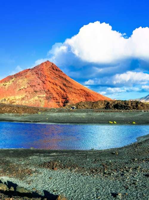 Unique volcanic nature of Lanzarote island with black sands and red mountains; Shutterstock ID 573901033