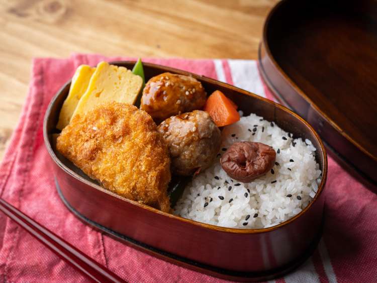 japanese style bento in wooden box with meat ball and croquette; Shutterstock ID 1867585483; purchase_order: n/a; job: Japan guide images; client: cunard_digital; other: 