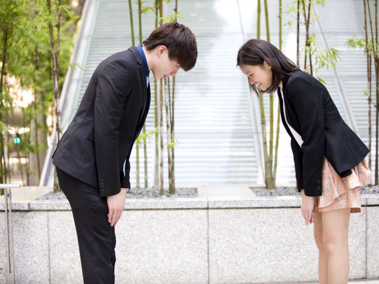 Young Asian business executives bowing to each other; Shutterstock ID 304118024; purchase_order: n/a; job: Japan guide images; client: cunard_digital; other: 