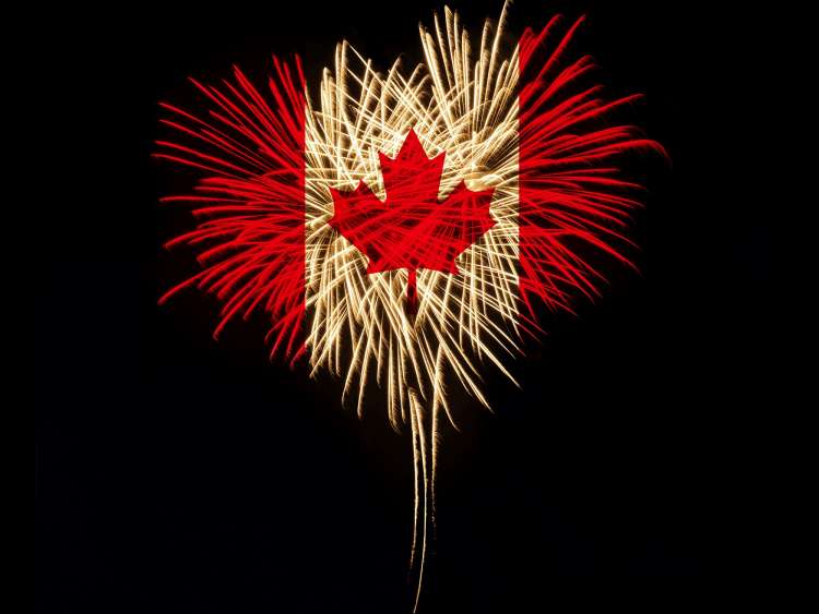 Fireworks in a heart shape with the Canada flag on a black background. Canada day. Welcome to Canada; Shutterstock ID 197319737; purchase_order: n/a; job: New England & Canada Guide; client: cunard-digital; other: As per agreed annual allowance