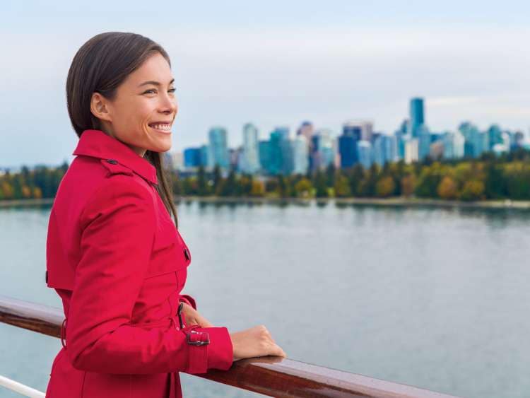 Canadian Vancouver cruise travel in autumn, Asian tourist enjoying view on Alaska cruise vacation. Chinese woman on deck of ship, British Columbia, Canada.; Shutterstock ID 632520788; purchase_order: n/a; job: New England & Canada Guide; client: cunard-digital; other: As per agreed annual allowance