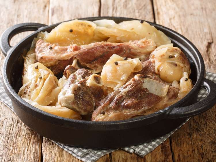 Farikal, or Lamb and Cabbage, is an old, traditional Norwegian dish closeup in a pan on the table. Horizontal