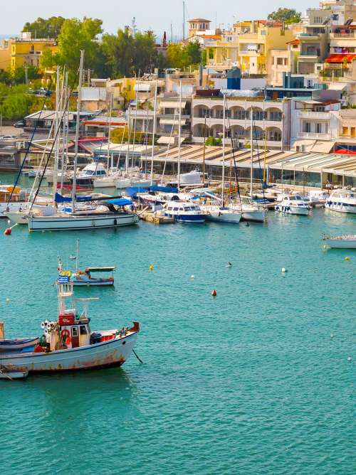 Harbour at Piraeus (near Athens), Greece, with shoreside cafes and establishments and fishing and sailing boats