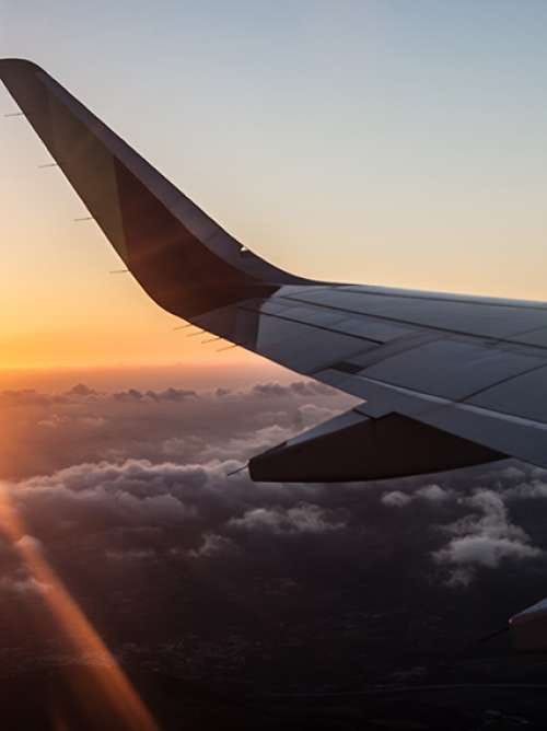 Sunset in airplane with wing - Shutterstock ID 680534296