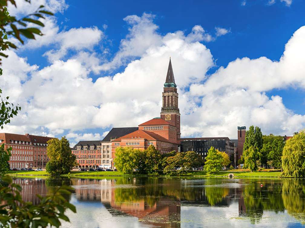 Kiel Town Hall during the day with reflection in the lake near by