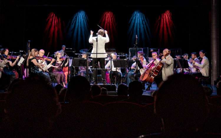 Antony Inglis conducts the National Symphony Orchestra on the Royal Court Theatre stage on Cunard's Queen Mary 2