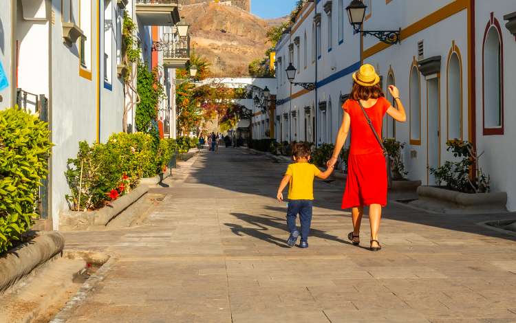 Mother and son exploring Puerto de Mogan, Gran Canaria