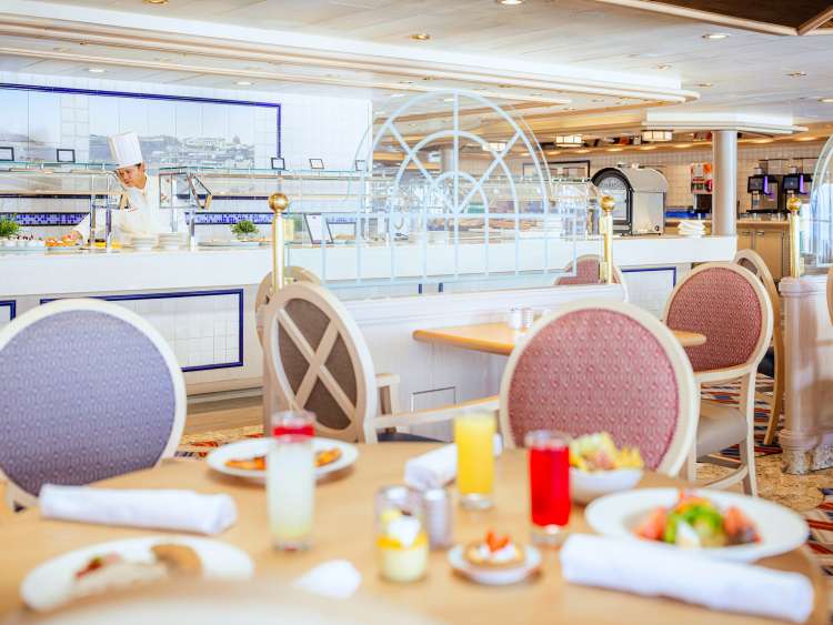 Table with food and drink in the Lido Restaurant on board Queen Victoria