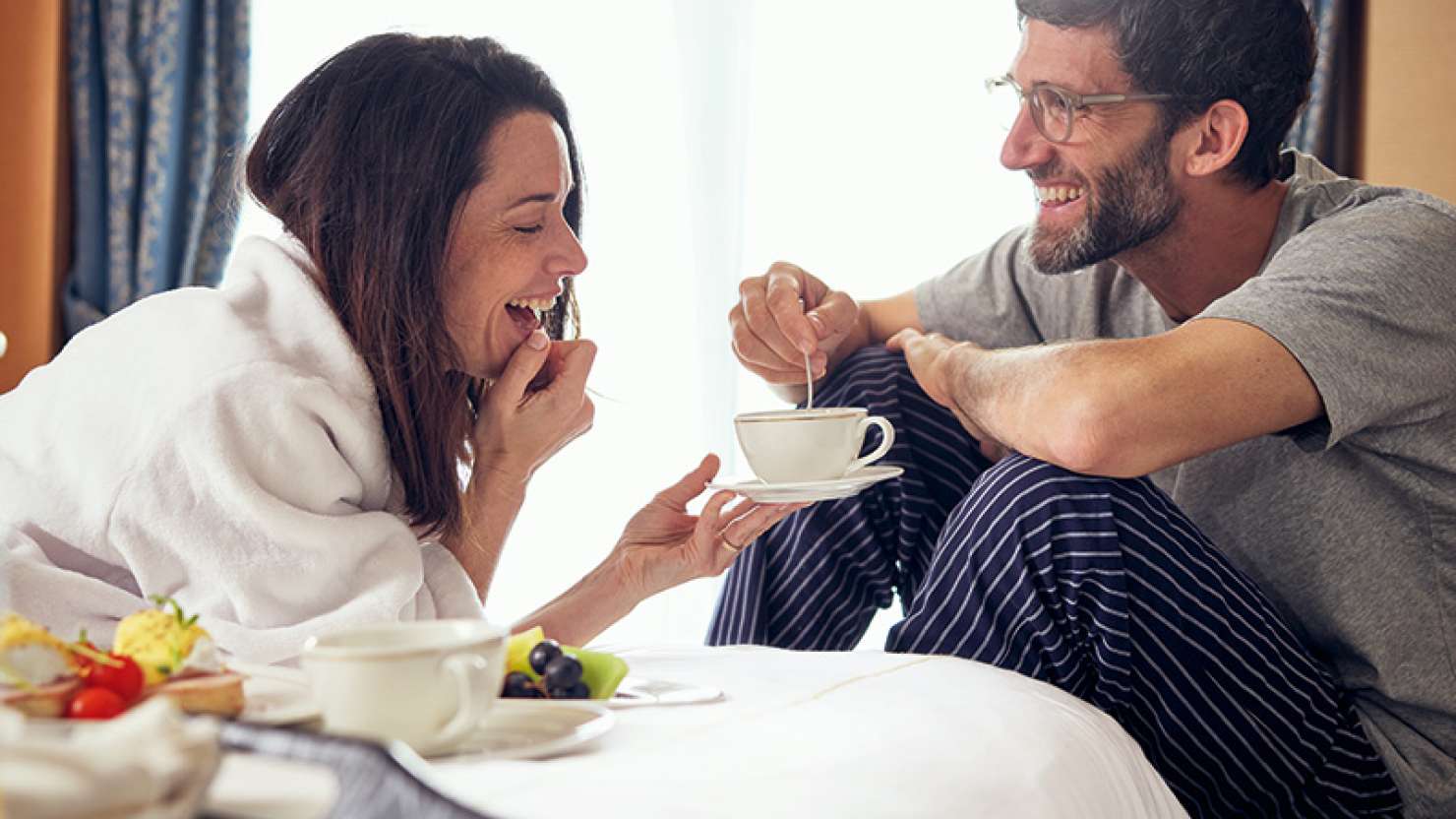 Couple enjoying breakfast in their stateroom on board a Cunard cruise ship