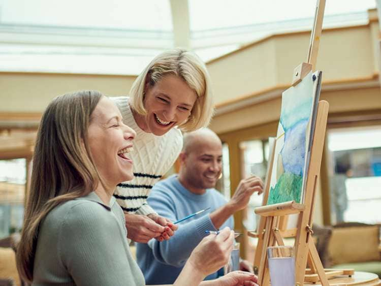 Guests participating in an art class on board a Cunard cruise ship