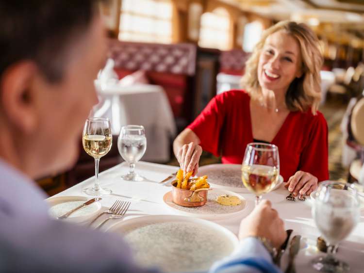 Guests enjoying Alternative Dining with wine on board a Cunard cruise ship