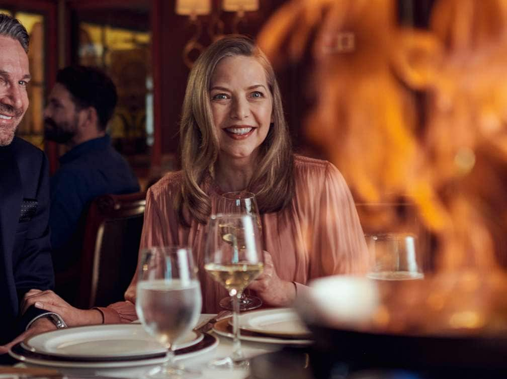 Guests are treated to a tableside flambé in the Queens Grill restaurant