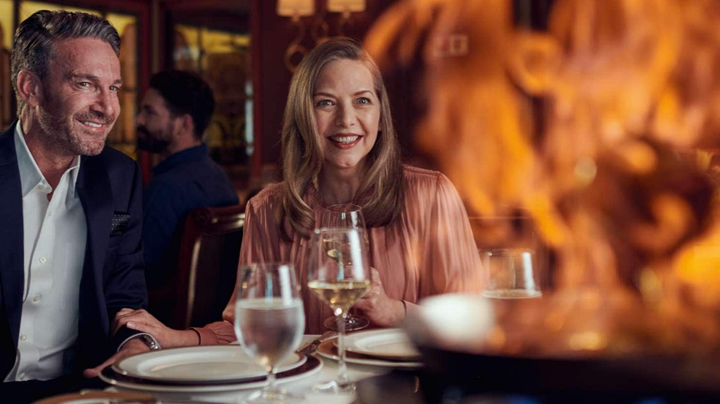 Guests are treated to a tableside flambé in the Queens Grill restaurant