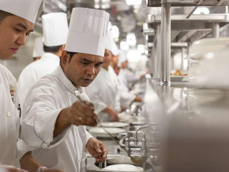 Chefs prepare dinner in the galley on Cunard's Queen Victoria