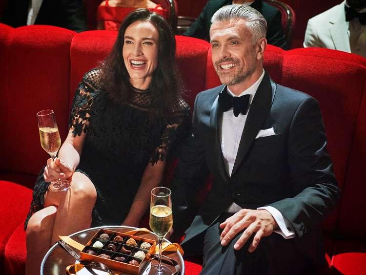 Guests enjoying Champagne and chocolates in the theatre