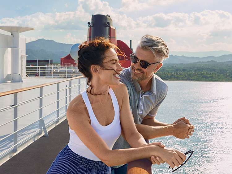 Brand shot of Man and Woman relaxing on deck