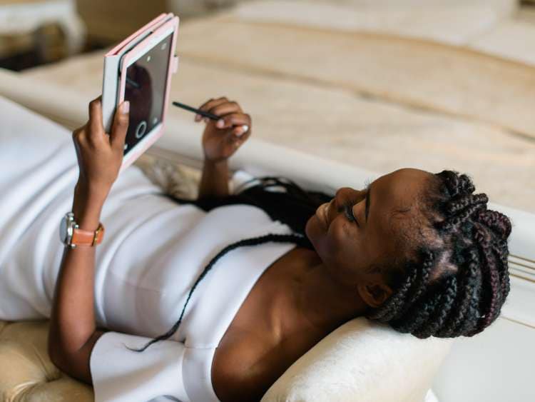 woman on the sofa and using her tablet. Vip hotel; Shutterstock ID 520529596; Purchase Order: -