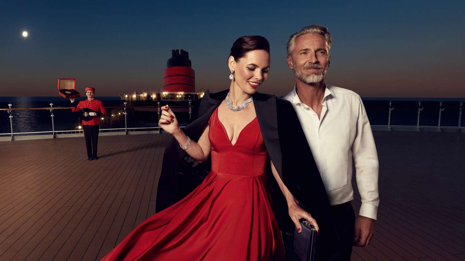 A couple in evening wear on the deck of a Cunard Queen