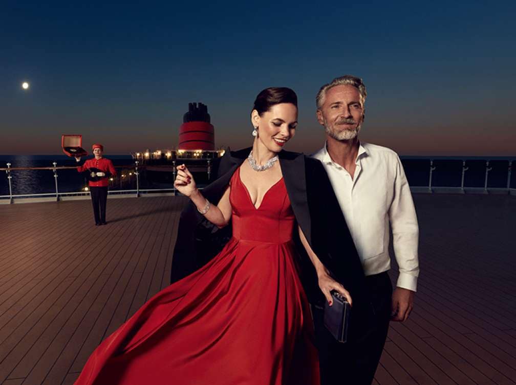 A couple in evening wear on the deck of a Cunard Queen