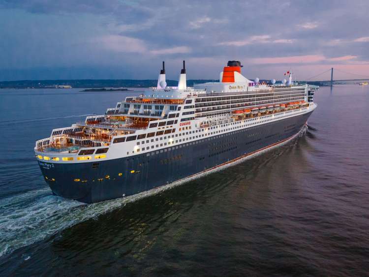 Stern view of Cunard's Queen Mary 2, showing deck levels and pools, at dusk