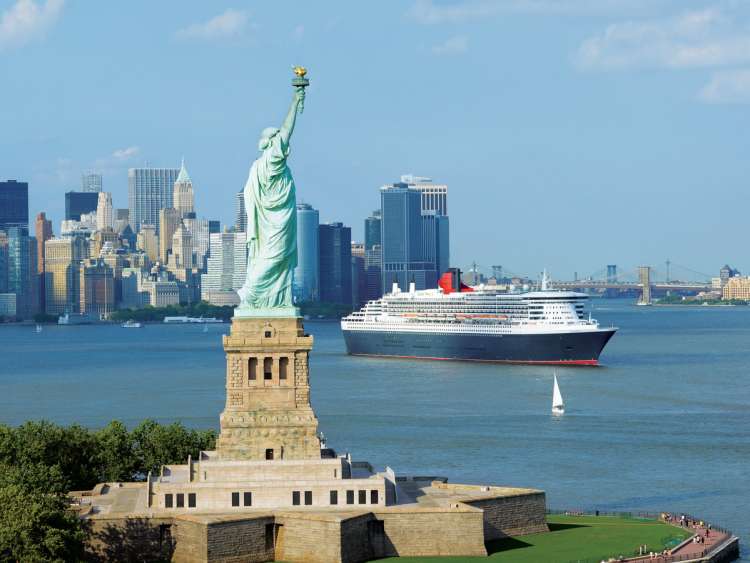 New York Harbour, New York City, USA – Saturday 6th. July 2013 - 
Queen Mary 2 bids farewell to New York and heads for Southampton on her milestone 200th crossing; to mark the beginning of the historic voyage from New York, the world’s most iconic ship performed a sail-by of the world’s iconic statue atop Liberty Island, the Statue of Liberty.  
Queen Mary 2 is the largest, longest, tallest, widest and most expensive liner ever built. Today, she is the only ocean liner in service and is the fastest passenger ship in the world. Since entering service in 2004 she has cemented her place in maritime history as the most famous passenger ship afloat today. In the course of Queen Mary 2’s 200 Atlantic crossings, Cunard estimates that half a million passengers have consumed 8.4 million cups of tea, 980,000 scones, 481,000 bottles of champagne, 644,000 eggs and 960,000 litres of milk. In total, 22.4 million meals have been served with over 600,000 nautical miles sailed.  And these figures do not take into account consumption on her annual World Cruise or sailings to the Canaries, Fjords, Iceland, the Low Countries, around Britain, up to Montreal and Quebec in Canada, and among the islands of the Caribbean. 