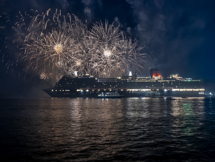 Fireworks light the sky above Queen Anne as she sails on her long-awaited maiden voyage