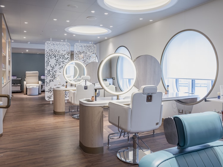 Salon on Queen Anne, showing treatment areas with sea views, circular lit mirrors, and pedicure area