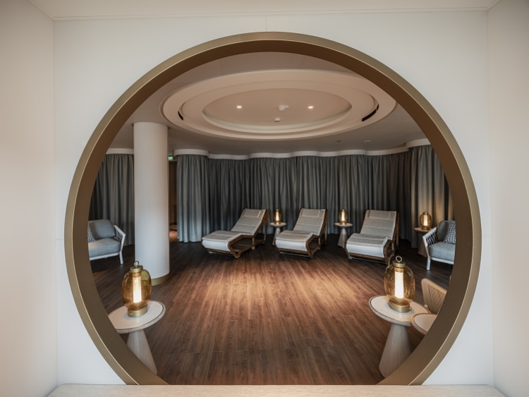 Relaxation room in Queen Anne's Mareel spa, showing loungers and soft lighting through a circular doorway