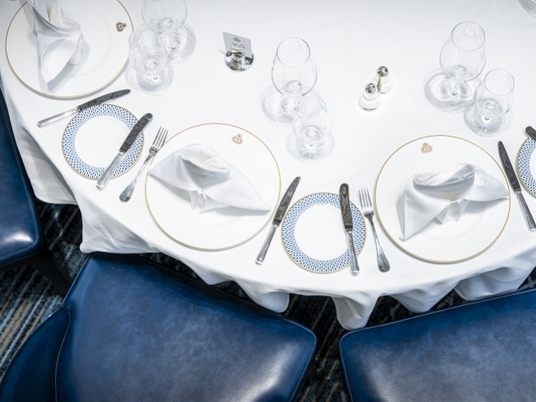 Top-down view of round table set for dinner in Queen Anne's Britannia restaurant 