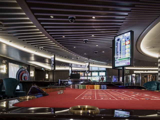 Casino on Queen Anne, with card tables, digital screens and large wall-mounted spinning wheel