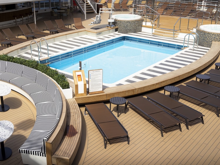 Diagonal view of Queen Anne's Panorama Pool Club, showing deck pool, whirlpools, deckchairs and seating area