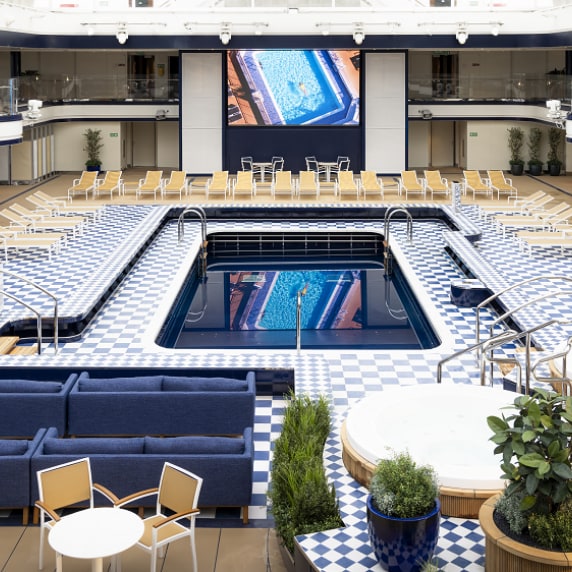 Daytime view of Queen Anne's Pavilion venue, showing pool, dual-deck seating and cinema screen